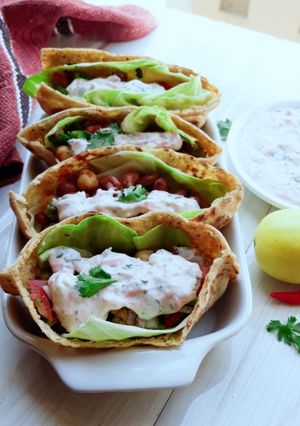 A picture of Pita Bread Chick Pea Kidney bean filling with Tzatziki sauce.