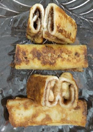 A picture of French toast filled with chocolate and banana.