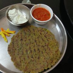 A picture of Bajra atta Dhebra with fresh fenugreek and green garlic.