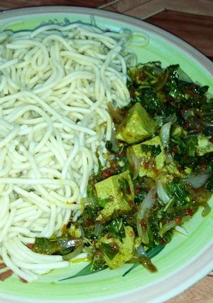 A picture of Spaghetti with green vegetable and egg moi moi.