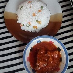 A picture of White rice and tomatoes stew.