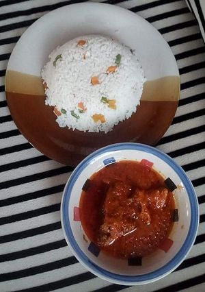 A picture of White rice and tomatoes stew.
