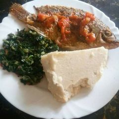 A picture of Ugali with Fish and Sukuma wiki.