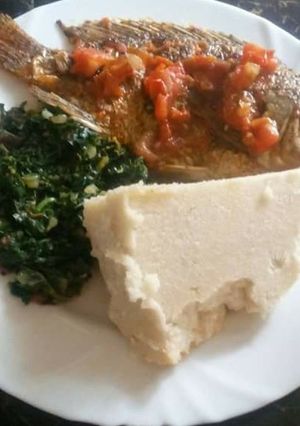 A picture of Ugali with Fish and Sukuma wiki.
