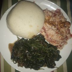 A picture of Ugali, fried amarantha and eggs.