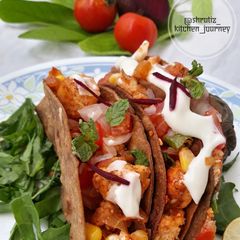 A picture of Ragi tacos with paneer and corn filling.