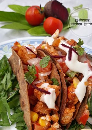 A picture of Ragi tacos with paneer and corn filling.