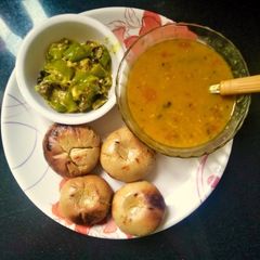 A picture of Rajasthani dal bati with mirch ke tipore(dal Bati & malai mirch).