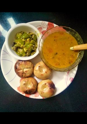 A picture of Rajasthani dal bati with mirch ke tipore(dal Bati & malai mirch).