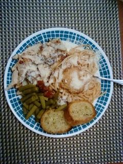 A picture of Chicken Parmesan With Spaghetti and Garlic Bread.