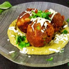A picture of Pasta veg cheese balls in creamy palak sauce.