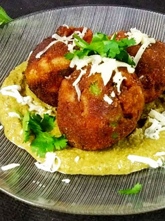 A picture of Pasta veg cheese balls in creamy palak sauce.