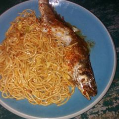 A picture of Spaghetti with fried fish.