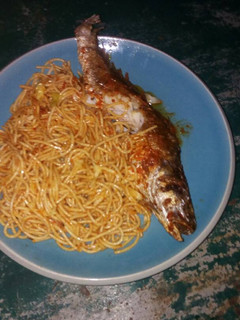A picture of Spaghetti with fried fish.