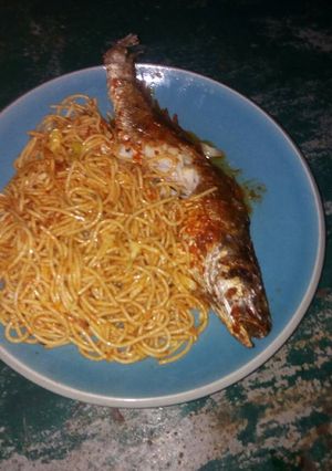 A picture of Spaghetti with fried fish.