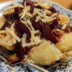A picture of Jacket potato with curried corned beef and beetroot for dinner.