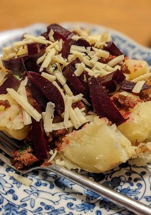 A picture of Jacket potato with curried corned beef and beetroot for dinner.