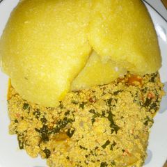 A picture of Egusi soup with yellow eba.