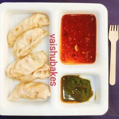 A picture of Momos with Red Chutney.
