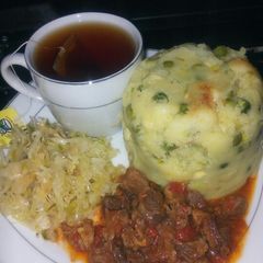 A picture of Simple peas mukimo with beef stew and black tea.