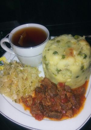 A picture of Simple peas mukimo with beef stew and black tea.