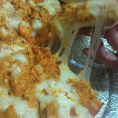 A picture of Chéésy cheese 🧀 chicken 🐔 pizza 🍕🍕.