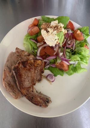 A picture of Lamb and salad.