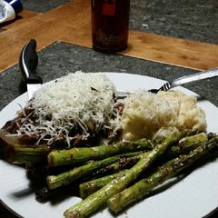 A picture of Brad's red wine NY steaks with grilled asparagus.