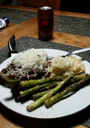 A picture of Brad's red wine NY steaks with grilled asparagus.