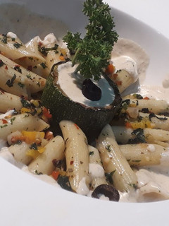 A picture of Penne aglio olio with backed zucchini and cheese mushroom sauce.