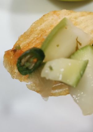 A picture of Mango salad with chips.