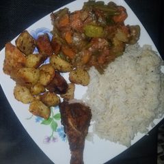 A picture of Veggie mix, roast potatoes and chicken with rice.