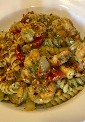 A picture of Penne Pasta with Shrimps, fire roasted red peppers, sautéed onions, corn in Avacado Lime Pesto Sauce.