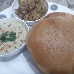 A picture of Poori with aloo ki chatpati sabji.