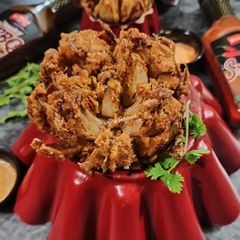A picture of Blooming Onion with Dipping Sauce.