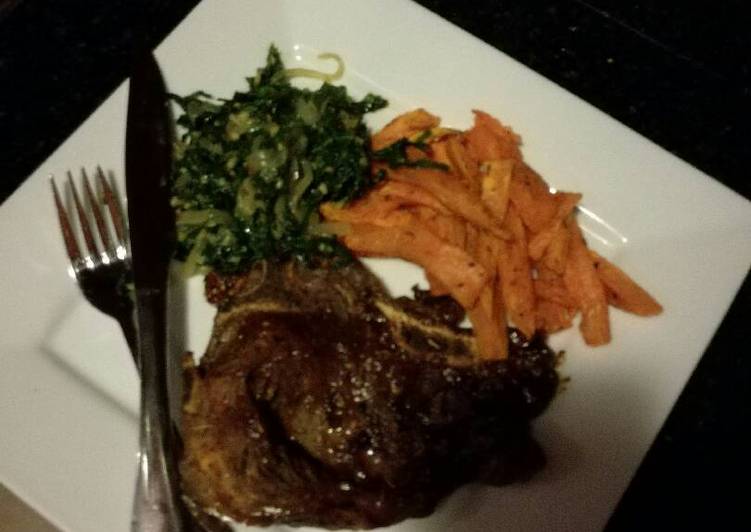 T-bone steak,sweet potato chips and sauteed spinach with onions