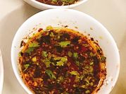 A picture of hot sauce and scallions