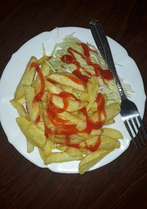 A picture of Healthy fries and raw salad.