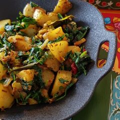 A picture of "Saag Aloo" Potato with Spinach.