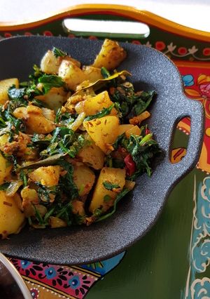 A picture of "Saag Aloo" Potato with Spinach.