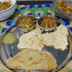 A picture of Rajasthani Thali Ker Sangri Sabji Jodhpuri Aloo with Dal Paratha Chutney and Papad (Lunch Thali).