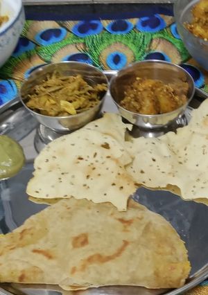 A picture of Rajasthani Thali Ker Sangri Sabji Jodhpuri Aloo with Dal Paratha Chutney and Papad (Lunch Thali).
