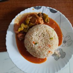 A picture of Chicken Jalfrezi with Egg Fried Rice.