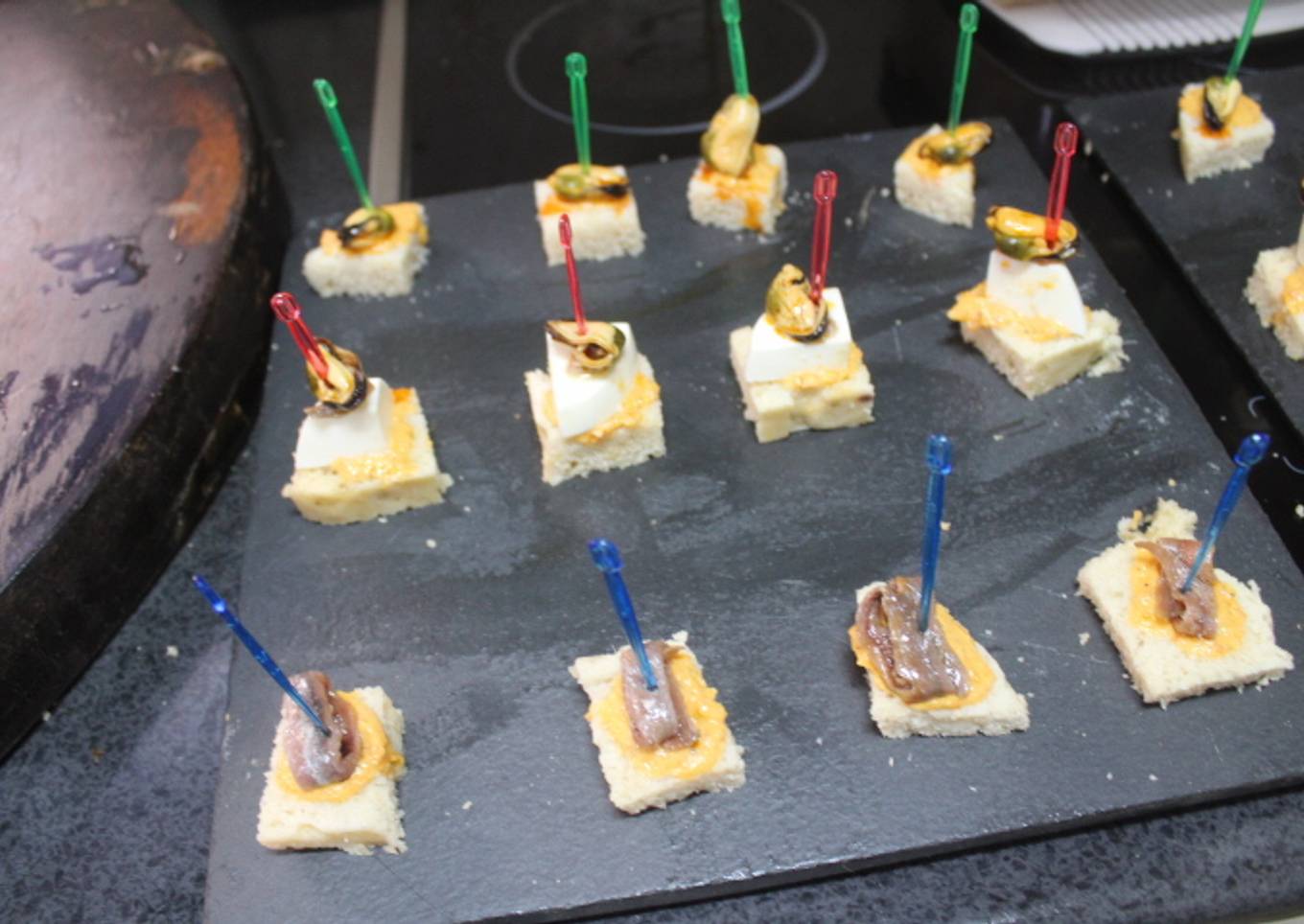 Cuadraditos de pan de molde con anchoas, queso y mejillones