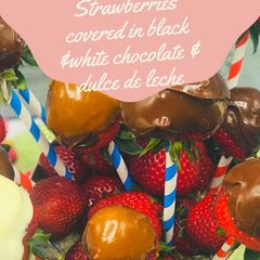 A picture of Strawberries covered in black &white chocolate and dulce de leche.