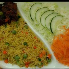 A picture of Fried rice garnished with peppered beef.