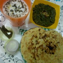 A picture of Palak saag, makke ki roti with buttermilk.
