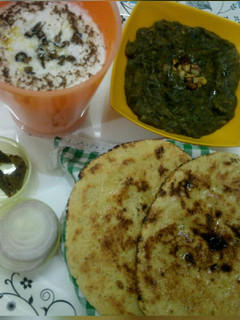 A picture of Palak saag, makke ki roti with buttermilk.
