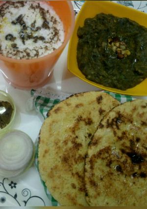 A picture of Palak saag, makke ki roti with buttermilk.