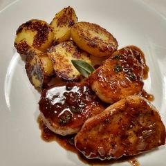 A picture of Pork Chops with Sage and Blackberry Pan Sauce.